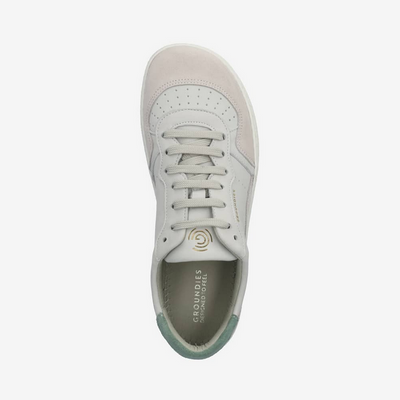 A photo of Groundies Nova sneakers made from leather and rubber soles. The sneakers are beige and white with pink/green accents on the heel, they also have perforation on the toe box. The right sneaker is shown over top facing downward against a white background. #color_beige-green-pink