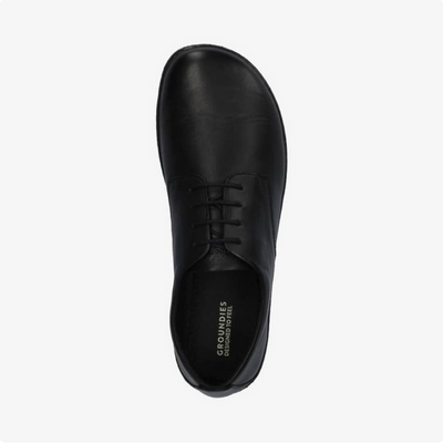 A photo of Groundies Palermo dress shoes made of leather upper and rubber soles. The shoes are a black color with black soles and dress sole detailing by the laces. The right shoe is shown facing upright over top against a white background. #color_black