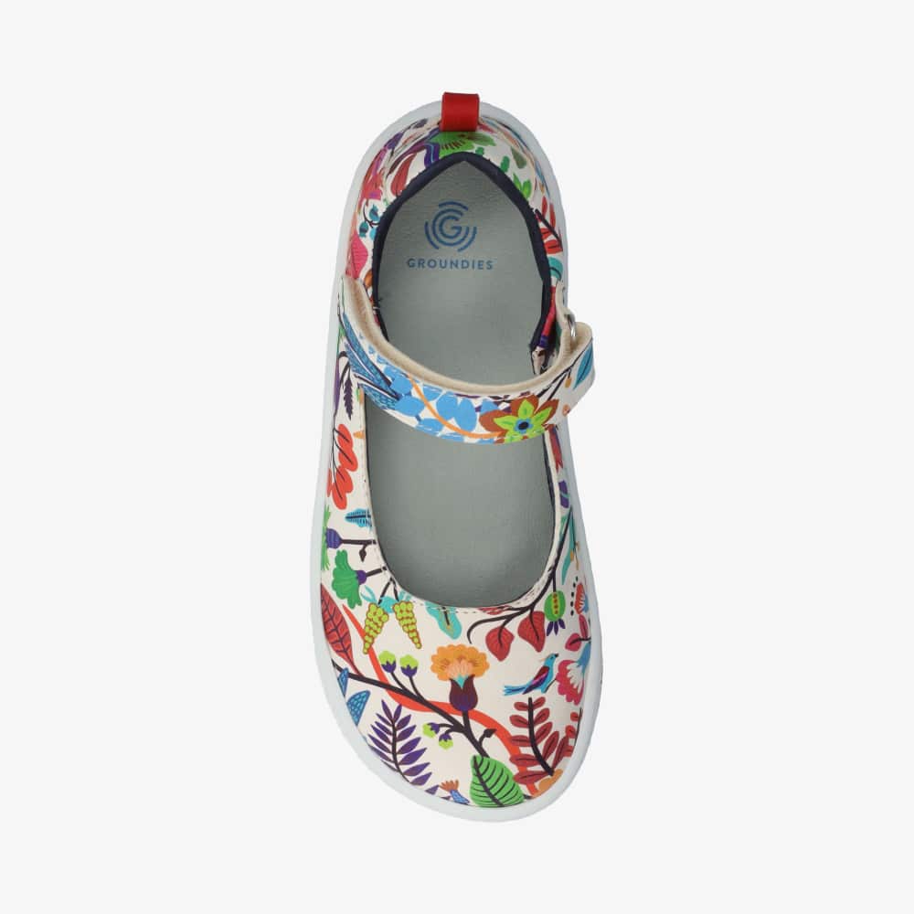 Photo 1 - A photo of Groundies Stella classic Mary Jane flats in a floral color print composed of assorted foliage and animals in all rainbow colors with white soles. Right shoe is shown from the right side against a white background. Photo 2 - Right shoe is shown from the top down against a white background. #color_color-print