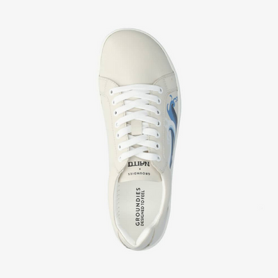 Photo 1 - A photo of off white Groundies Universe sneakers made with classic sneaker details and a blue waves NAITO design. Right shoe is shown from the right side against a white background. Photo 2 - Right shoe is shown from the top down against a white background.  #color_off-white-waves