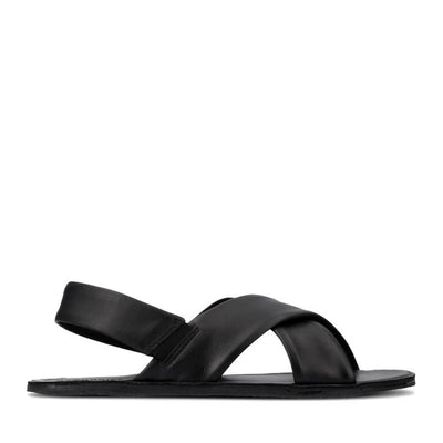 Photo 1 - A photo of Groundies Verona leather sandals in black. Two thick straps make an X across the foot while a thinner strap keeps the sandal secure to the foot. The right shoe is shown from the right against a white background. Photo 2 - Left shoe is shown floating diagonally from the left against a white background.  #color_black