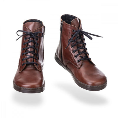 A photo of Peerko Go combat boots made with smooth leather, fleece, and rubber soles. The boots are cognac in color, fleece lined, with a zipper at the side. Both boots are shown floating forward angled slightly to the right against a white background. #color_cognac