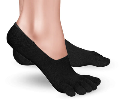 A photo of Knitido low cut toe socks made with cotton, nylon, polyester, and elastane. The socks are a black color. A woman is shown from ankle down wearing the low cut socks, she is facing to the right with right foot’s heel lifted slightly off the floor against a white background. #color_black