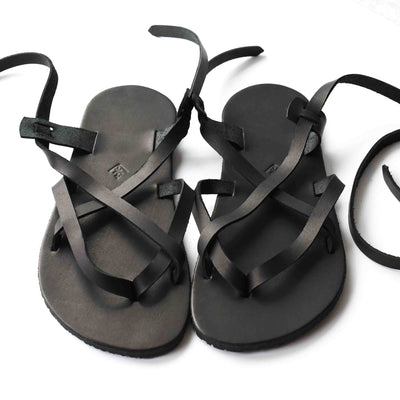 a black leather strappy sandal shown from above on a white background #color_black