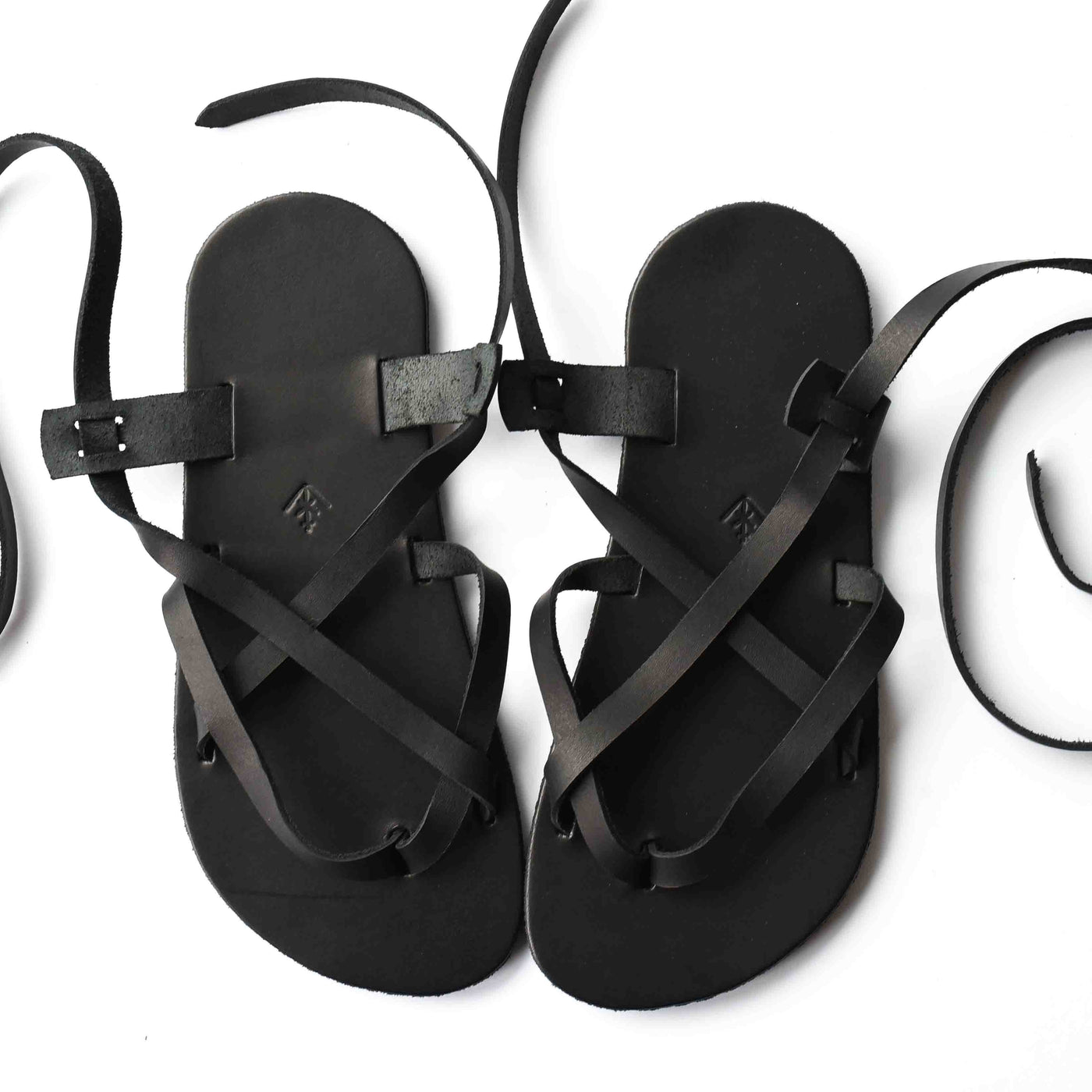 a black leather strappy sandal shown from above on a white background #color_black