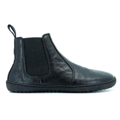 A photo of Mukishoes felted-wool-lined, leather Chelsea boots in black. Boots have elastic pannels on both sides of the shoe and a pull tab at the top of the ankle opening. Soles are black in color and are stitched to the leather. The right boot is shown here from the right side against a white background. #color_black