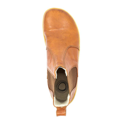 A photo of Mukishoes felted-wool-lined, leather Chelsea boots in caramel. Boots have brown elastic pannels on both sides of the shoe and a pull tab at the top of the ankle opening. Soles are a natural gum rubber color and are stitched to the leather. The right boot is shown here from the top down against a white background. #color_caramel