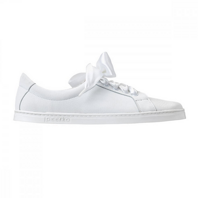 A photo of white Peerko Celebrate sneakers made with leather and recyclable soles. Sneakers have a slight sparkle and laces are ribbon. Shown from the right side against a white background in this photo. #color_white