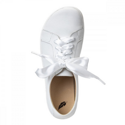 A photo of white Peerko Celebrate sneakers made with leather and recyclable soles. Sneakers have a slight sparkle and laces are ribbon. Shown from the top down against a white background in this photo. #color_white