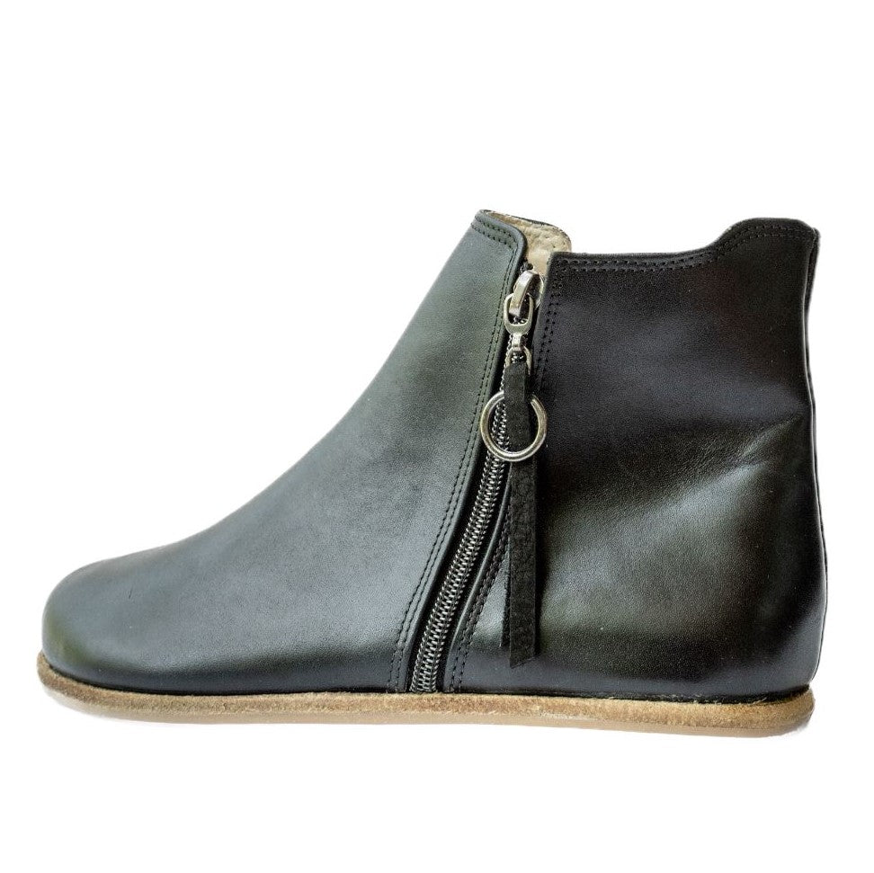 A photo of designed by Anya Rosa boots made from leather and rubber soles. The boots are black in color, they are a Chelsea boot style with a zipper on the sides. One boot is shown from the left side against a white background. #color_black-smooth-leather