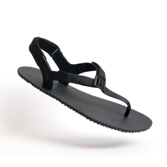 A photo of black Shamma Warrior adventure sandals made with fabric straps and a rubber sole. Shown floating diagonally against a white background. #color_black