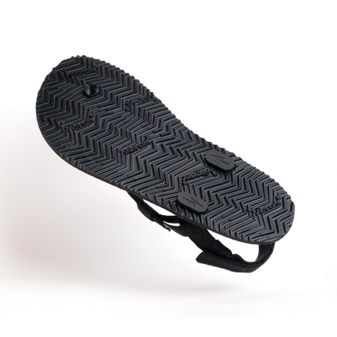 A photo of black Shamma Warrior adventure sandals made with fabric straps and a rubber sole. Shown floating from the sole of the shoe against a white background. Soles have lots of traction. #color_black