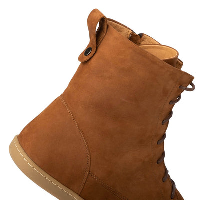 A photo of the Shapen Cozy lace up boots made from a water resistant nubuck leather upper, wool lining, and brown rubber soles. The boots are brown in color with brown laces and have a zipper on the inner side. The right boot is shown from the right side focused on the top back of the boot where there is a leather tab to assist in pulling the shoes on, on a white background. #color_brown