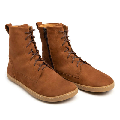 A photo of the Shapen Cozy lace up boots made from a water resistant nubuck leather upper, wool lining, and brown rubber soles. The boots are brown in color with brown laces and have a zipper on the inner side. Both boots are shown together from the front right side on a white background. #color_brown