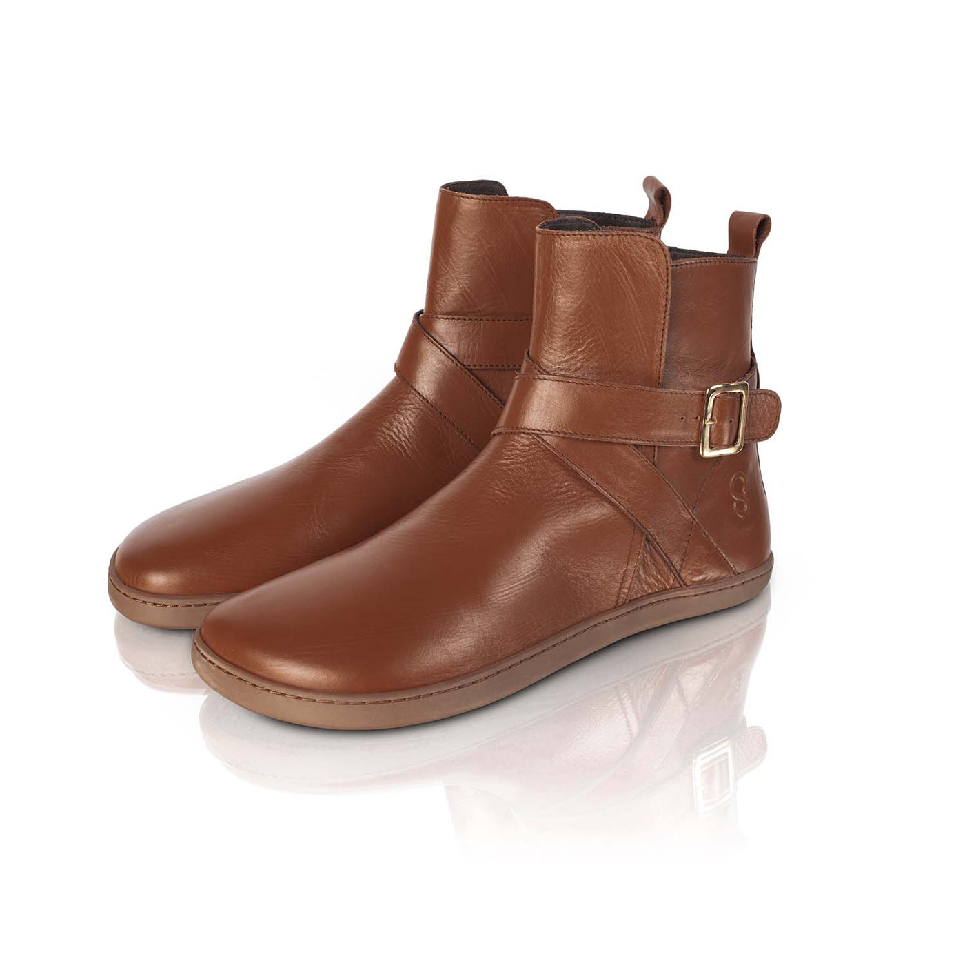 A photo of the Shapen Divine ankle boots made with a smooth leather upper, a microline lining, and rubber soles. The boots are brown in color and have an ankle strap with a gold buckle, as well as a side zipper. Both boots are shown together from the front left on a white background. #color_brown