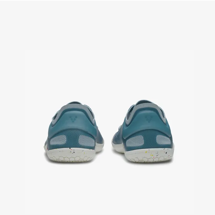A photo of Vivobarefoot Primus lite sneakers made from recycled plastic and a rubber sole. The athletic sneakers are a blue haze color with white soles spotted with color with the vivobarefoot logo on the side. Both shoes are shown beside each other from the back against a white background. #color_blue-haze