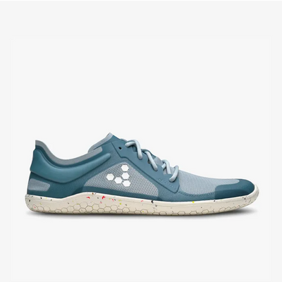 A photo of Vivobarefoot Primus lite sneakers made from recycled plastic and a rubber sole. The athletic sneakers are a blue haze color with white soles spotted with color with the vivobarefoot logo on the side. The left shoe is shown from the right side against a white background. #color_blue-haze
