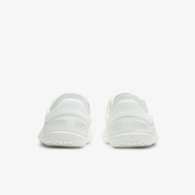 A photo of Vivobarefoot Primus lite sneakers made from recycled plastic and a rubber sole. The athletic sneakers are a white color with white soles and the vivobarefoot logo on the side. Both shoes are shown beside each other from the back against a white background. #color_bright-white
