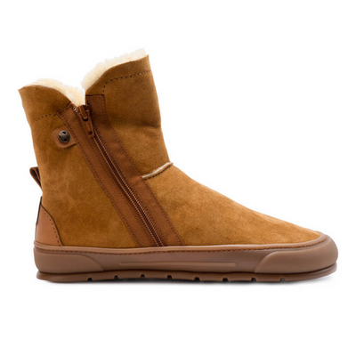 A photo of Zapatos Feroz Alcoy made with suede, sheepskin, and rubber soles. The boots are nut brown in color with rubber around the soles and a zipper on the side. One boot is shown from the right against a white background. #color_nut-brown